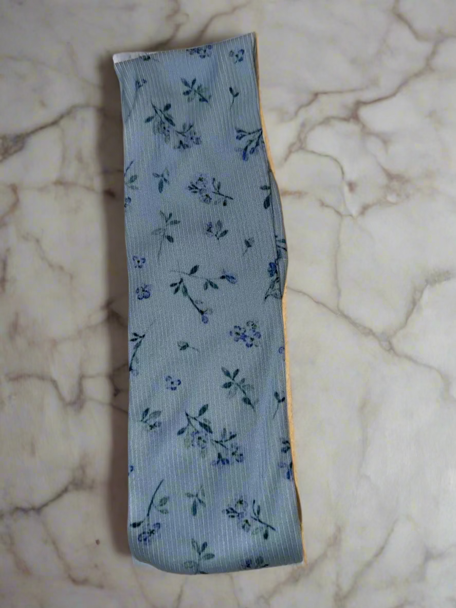 Floral-patterned blue fabric strip on a beige background