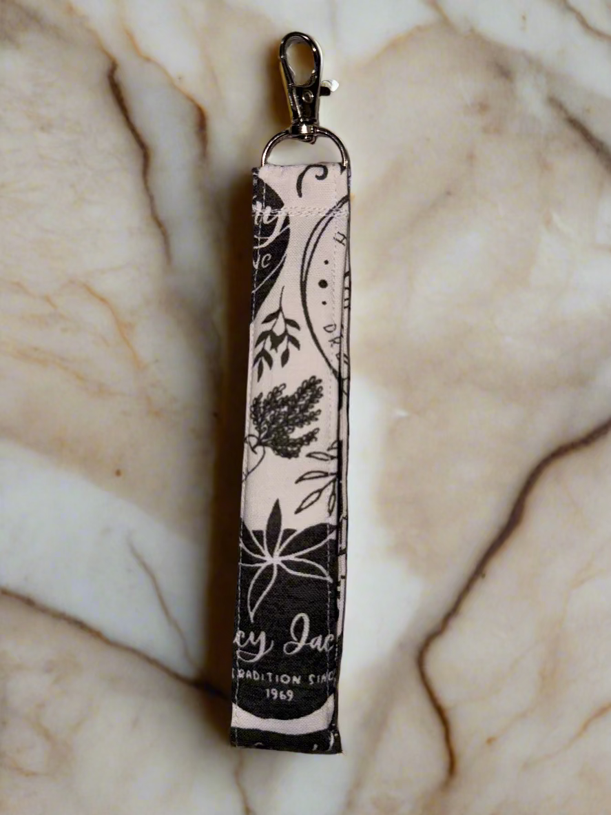 Keychain with floral design on a textured fabric background