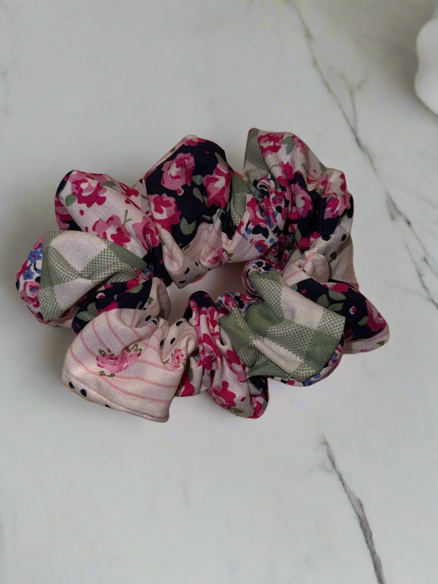 Set of floral and patterned scrunchies on a beige fabric background